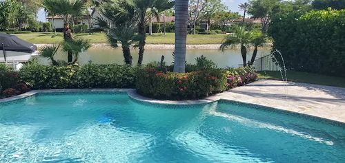 A curved pool with fountain jets running along the edge
