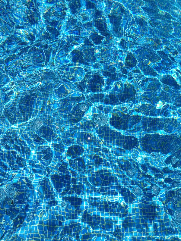 Sunlight moving across the clear water of a well kept residential pool